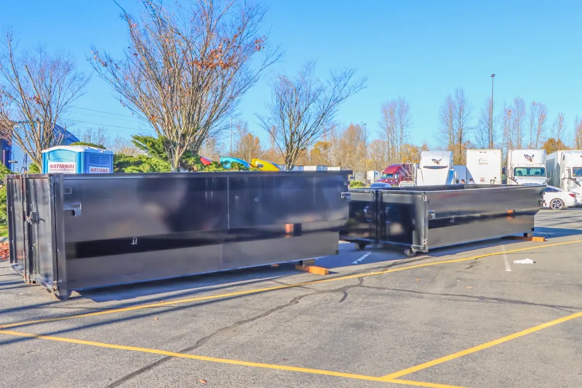 Professional dumpster rental service with roll-off container on residential driveway in San Marino